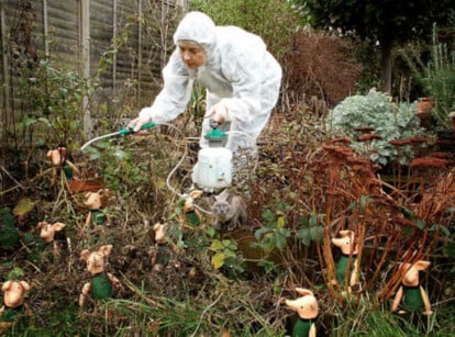 Someone in protective suit spraying